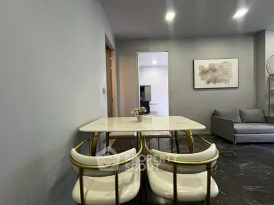 Modern dining area with elegant marble table and stylish chairs in a cozy living space.