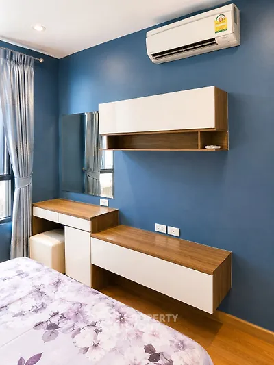 Modern bedroom with stylish furniture and air conditioning in a cozy apartment.