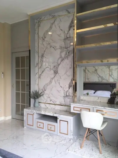 Luxurious marble-accented bedroom with elegant built-in vanity and modern decor.