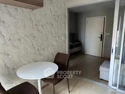 Modern apartment interior with marble accent wall and sliding glass door