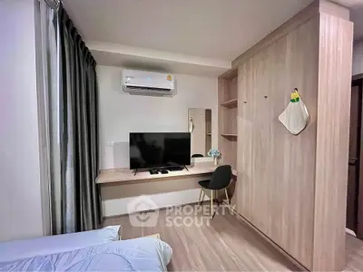 Modern bedroom with sleek wooden furniture and wall-mounted TV, perfect for urban living.
