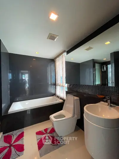 Luxurious modern bathroom with sleek black tiles and stylish fixtures