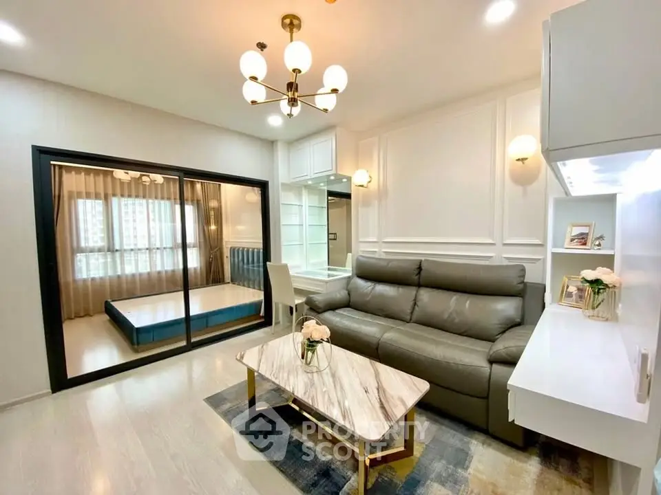 Modern living room with elegant decor and view into stylish bedroom
