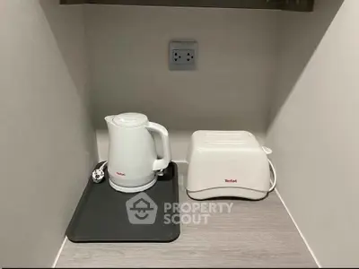 Compact kitchen corner with kettle and toaster on countertop
