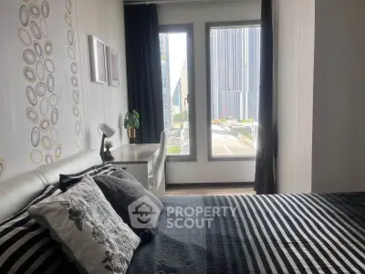 Modern bedroom with city view, stylish decor, and ample natural light.