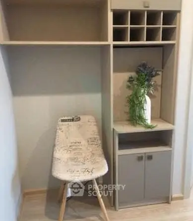Stylish modern storage unit with decorative chair and shelving, perfect for organizing any space.