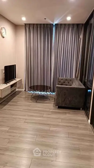Modern living room with sleek furniture and elegant curtains in a stylish apartment.