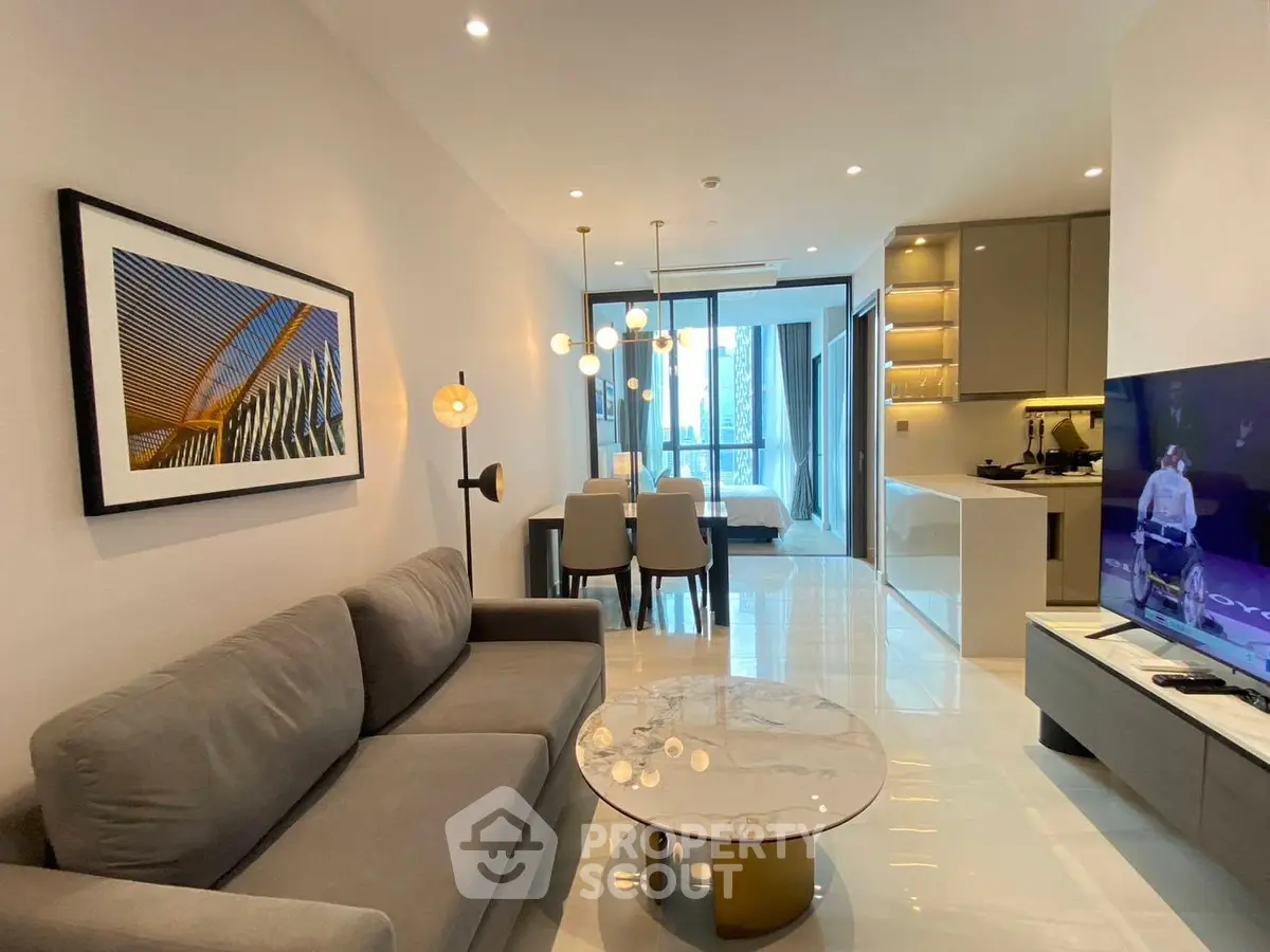 Modern open-plan living room with sleek kitchen and stylish decor