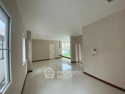 Spacious empty living room with large windows and modern design