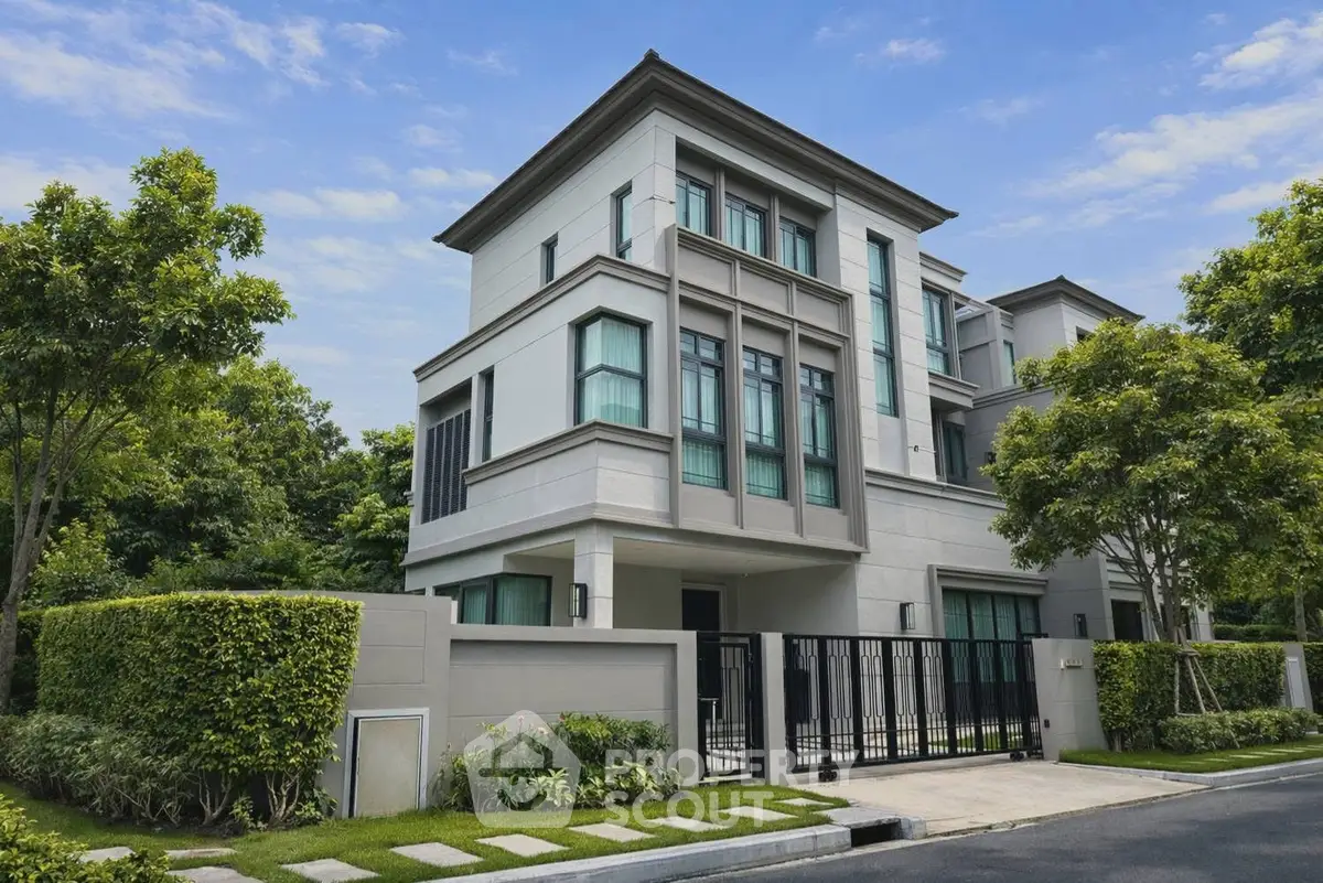 Luxurious modern house with lush greenery and sleek architecture in a serene neighborhood.