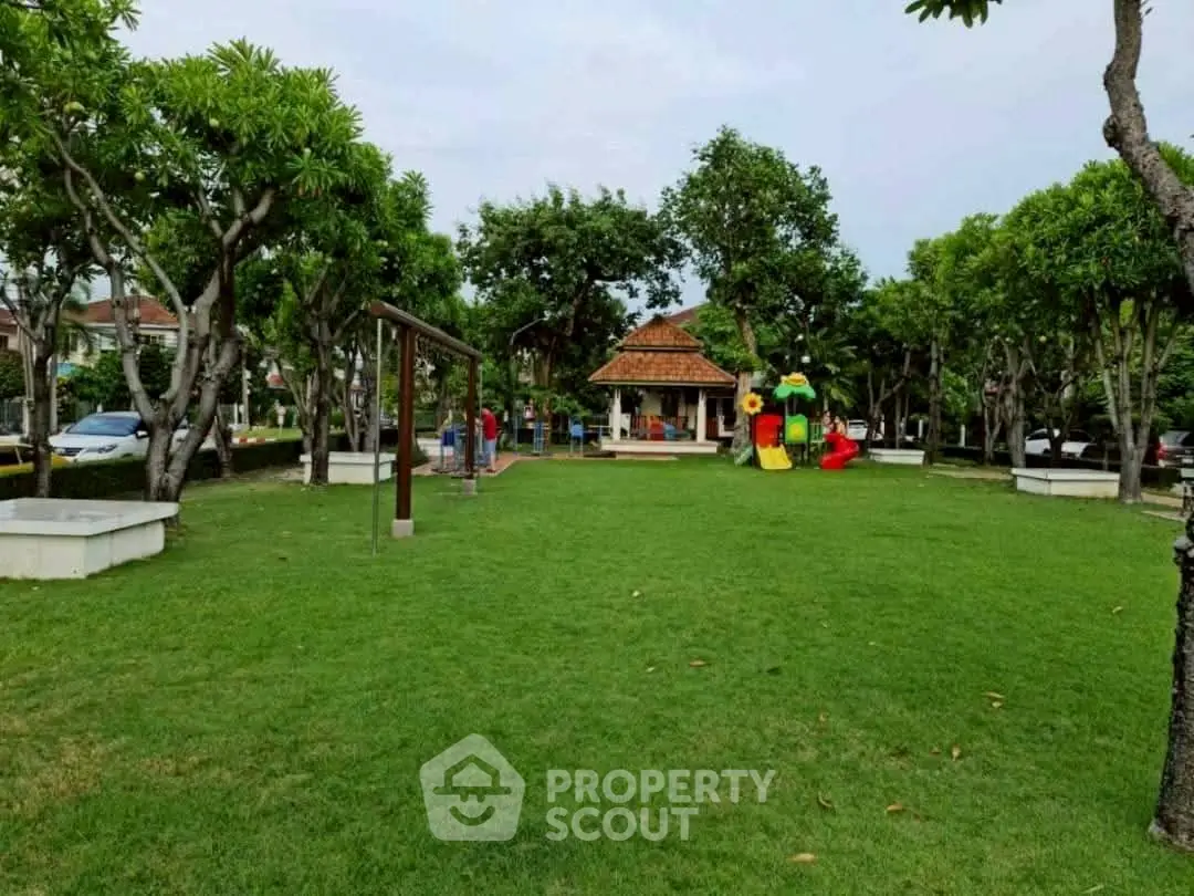 Charming community park with lush greenery and playground, perfect for family activities.