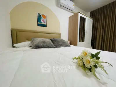 Cozy bedroom with modern decor and air conditioning, featuring a comfortable bed and stylish wardrobe.