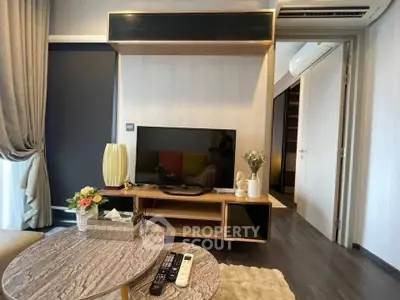 Modern living room with stylish decor and entertainment center in a cozy apartment.