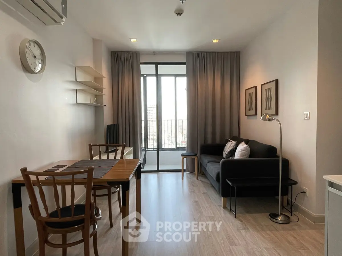 Modern living room with stylish decor and balcony view in a contemporary apartment.