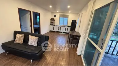 Spacious living room with modern decor and large windows for natural light.
