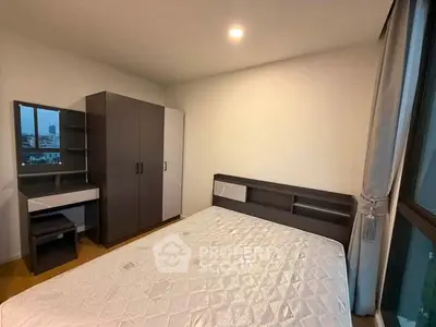 Modern bedroom with stylish furniture and large window offering city views.