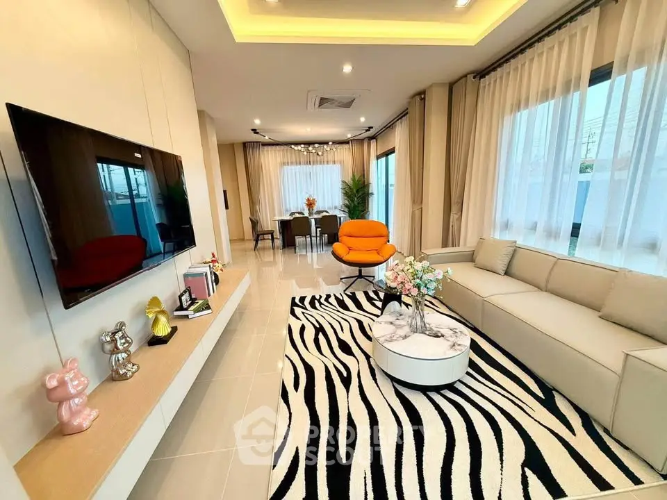 Modern living room with stylish decor, large windows, and open layout for a spacious feel.