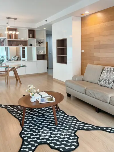 Modern living room with stylish decor and open layout, featuring a cozy sofa and elegant coffee table.