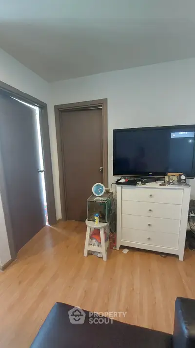 Cozy living room with wooden flooring and modern TV setup