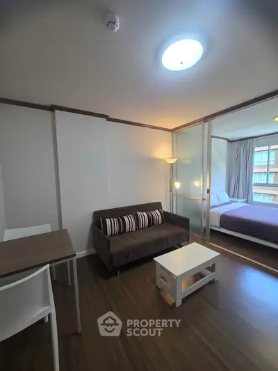 Modern apartment interior with cozy living room and bedroom view