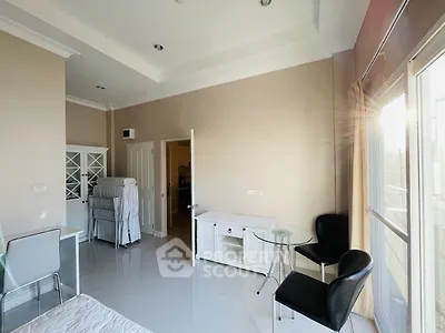 Bright and airy bedroom with modern furnishings and large windows for natural light.