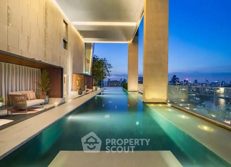 Luxurious rooftop infinity pool with stunning city skyline view at sunset.