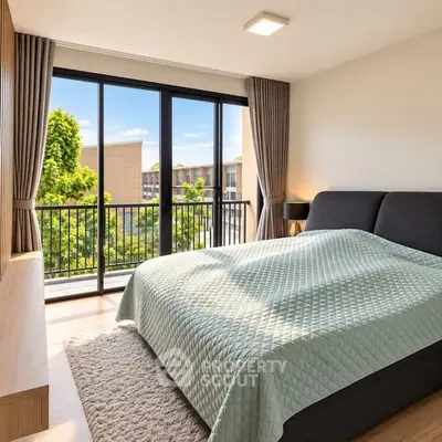 Bright and spacious bedroom with large windows and a view of greenery, featuring modern decor and a cozy atmosphere.