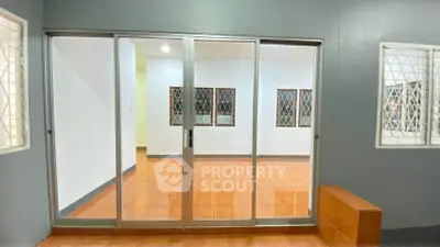 Spacious interior with sliding glass doors and tiled flooring, perfect for modern living.
