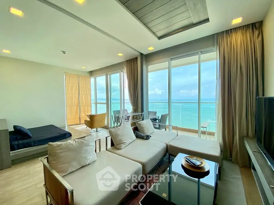 Luxurious beachfront living room with stunning ocean view and modern furnishings.