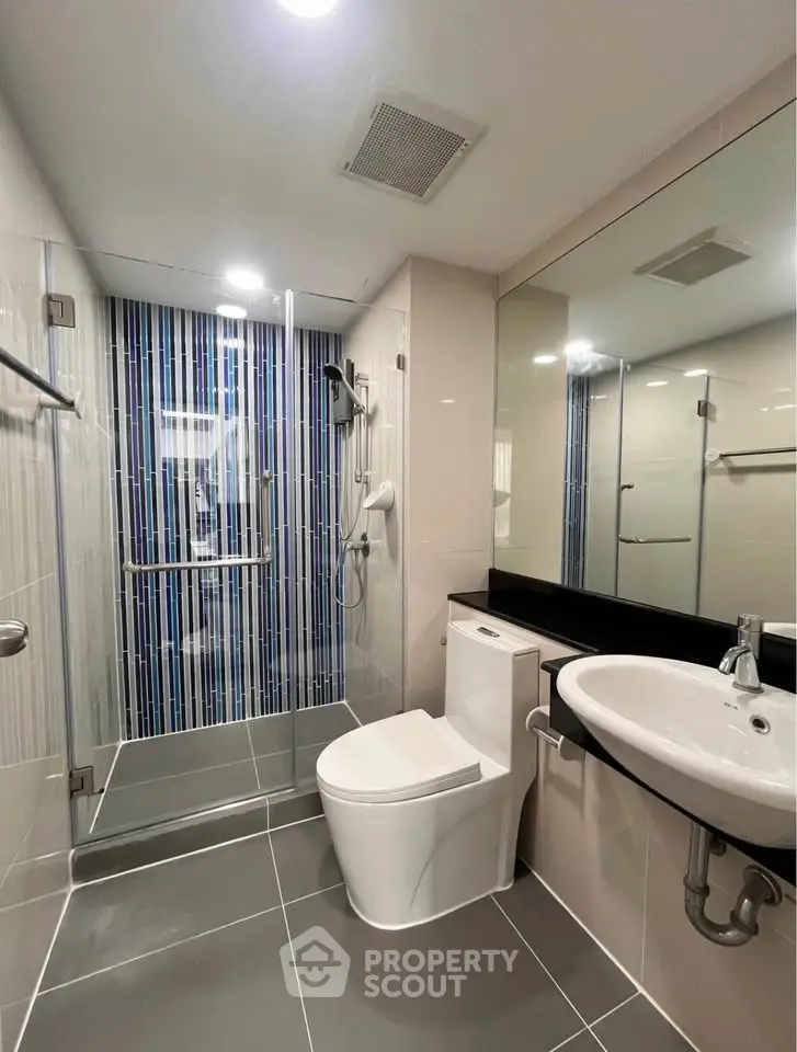 Modern bathroom with glass shower and sleek fixtures