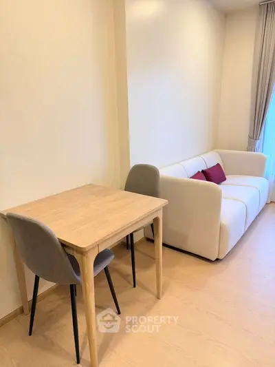 Modern living room with cozy sofa and stylish dining table in bright apartment.