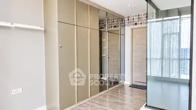 Spacious modern bedroom with mirrored wardrobe and large windows