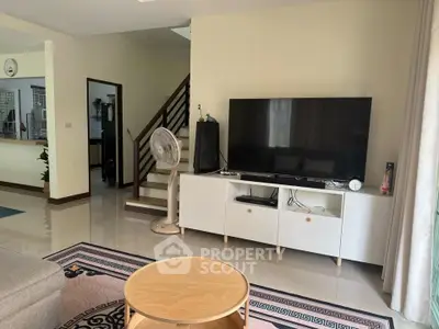 Spacious living room with modern decor and entertainment setup