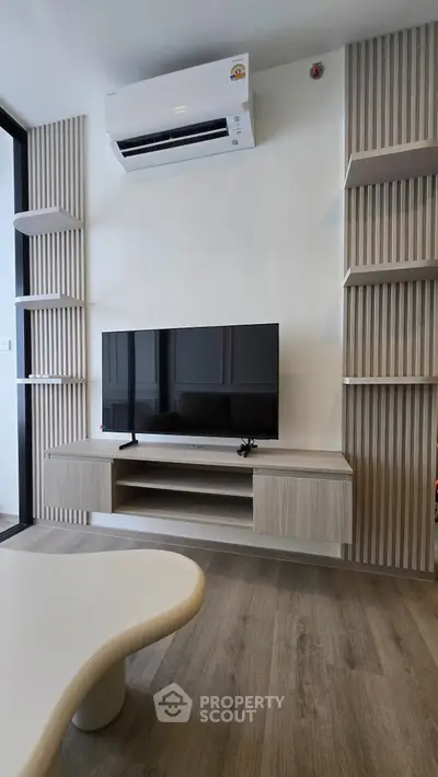 Modern living room with sleek TV unit and air conditioning, perfect for contemporary urban living.