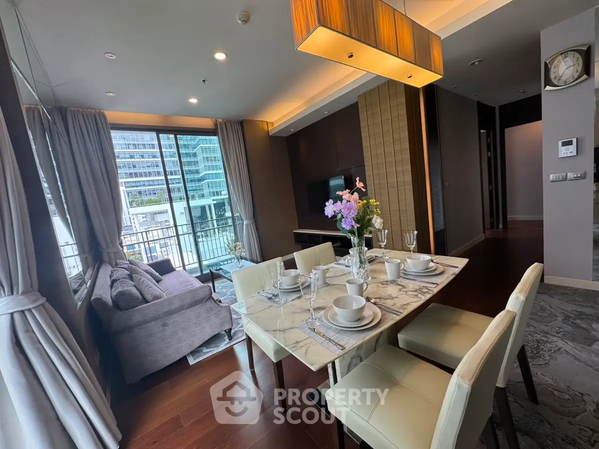 Luxurious modern living room with elegant dining area and city view balcony.