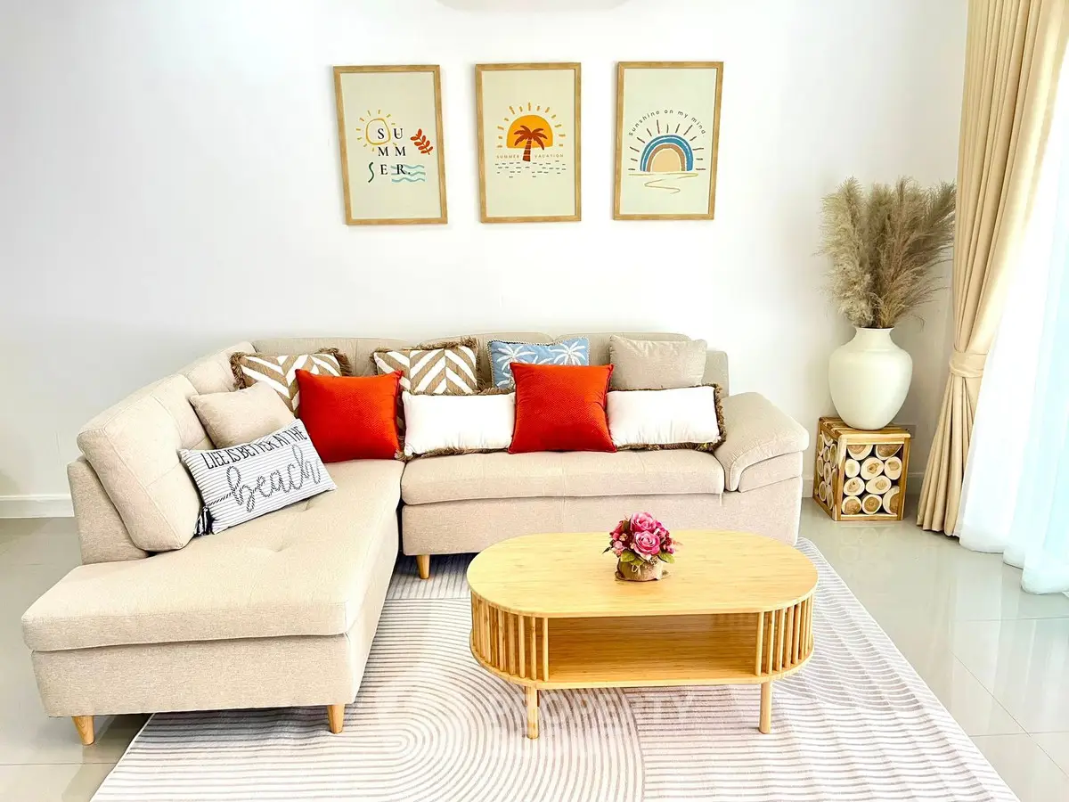 Chic living room with modern beige sofa, vibrant cushions, and stylish decor for a cozy ambiance.