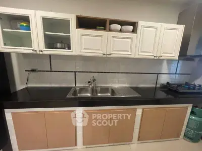 Modern kitchen with sleek black countertop and gas stove