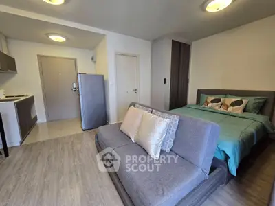 Modern studio apartment with cozy living area and stylish kitchen