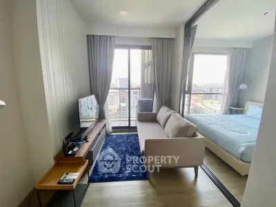 Modern studio apartment with cozy living area and city view
