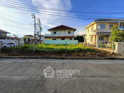 Vacant lot in suburban neighborhood with potential for new construction.