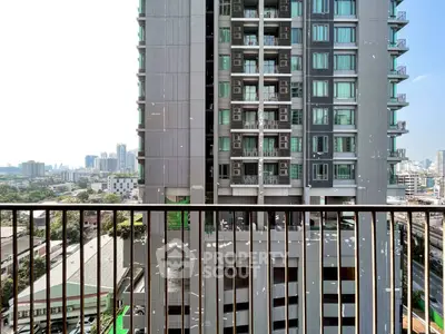 Stunning city view from a high-rise balcony with modern building facade