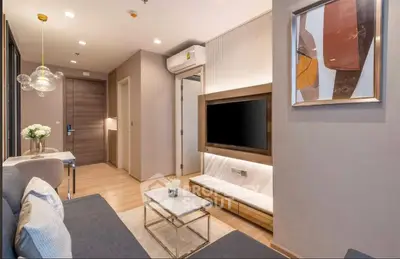 Modern living room with stylish decor and wall-mounted TV in a cozy apartment.
