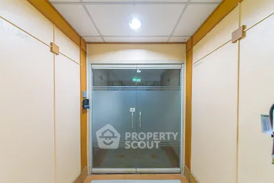 Modern building entrance with glass doors and bright lighting