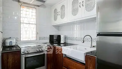 Charming kitchen with modern appliances and farmhouse sink in cozy home