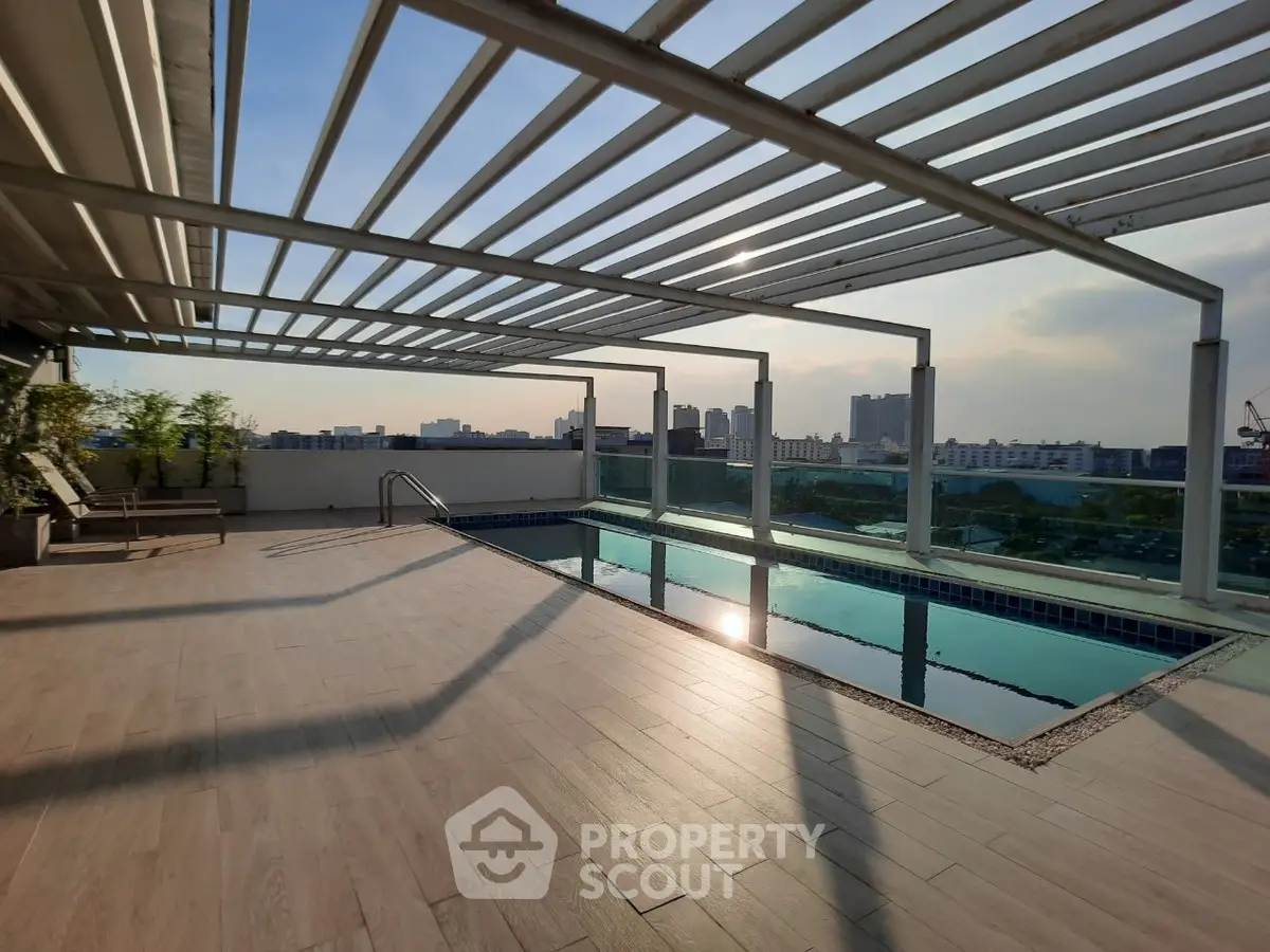 Stunning rooftop pool with city skyline views and modern pergola design.