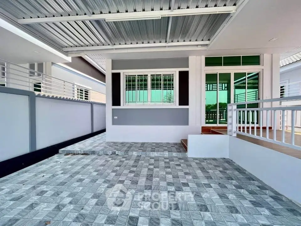 Modern home exterior with tiled patio and sleek design, perfect for contemporary living.