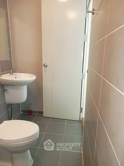 Modern bathroom with sleek tiles and compact design