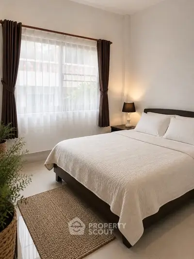 Cozy bedroom with elegant decor and natural light, perfect for relaxation.