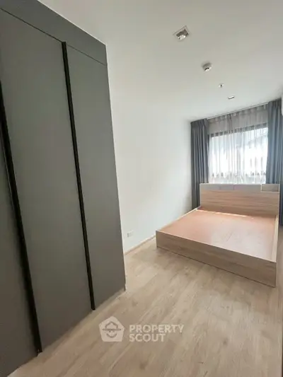 Spacious modern bedroom with large wardrobe and natural light