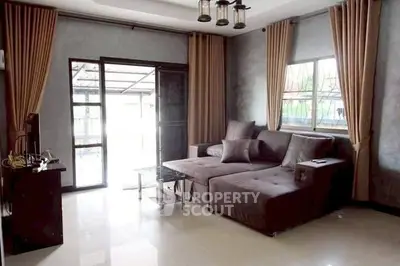 Spacious living room with modern decor and large windows for natural light.